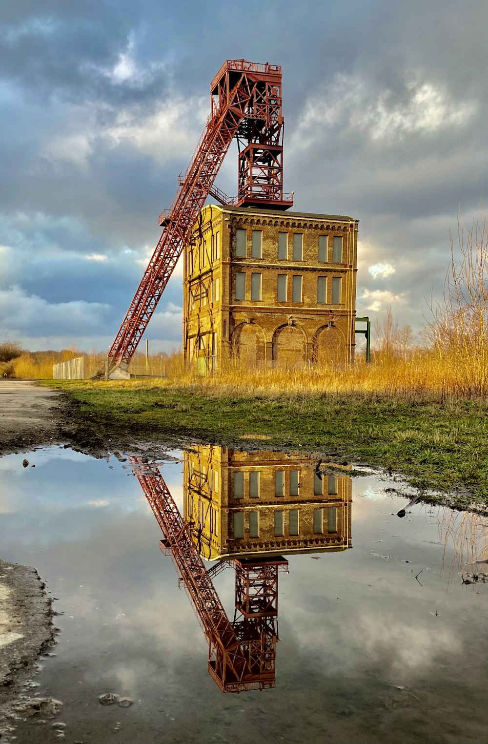 brown concrete building beside body of water during daytime