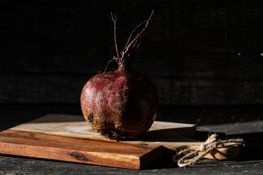 red and brown round fruit on brown wooden table