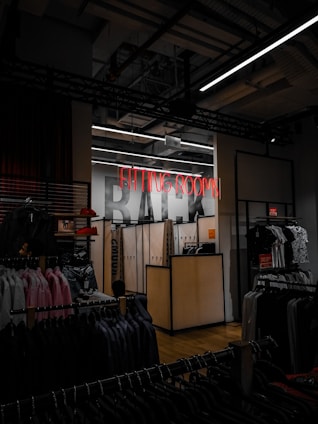 a clothing store with a neon sign above it