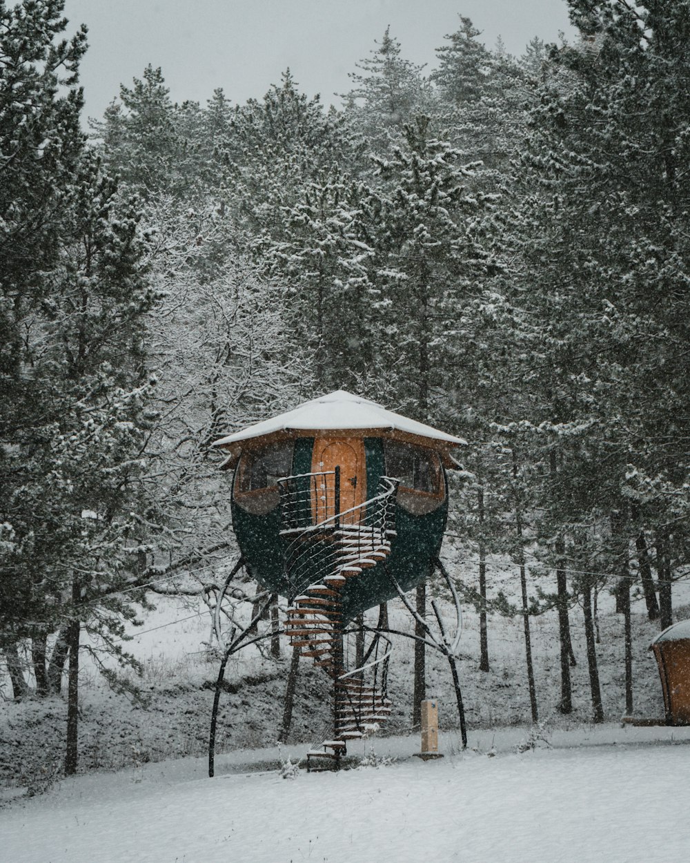 brown wooden hanging bird cage on snow covered ground