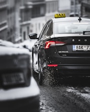 black porsche 911 on snow covered road during daytime