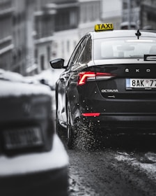 black porsche 911 on snow covered road during daytime
