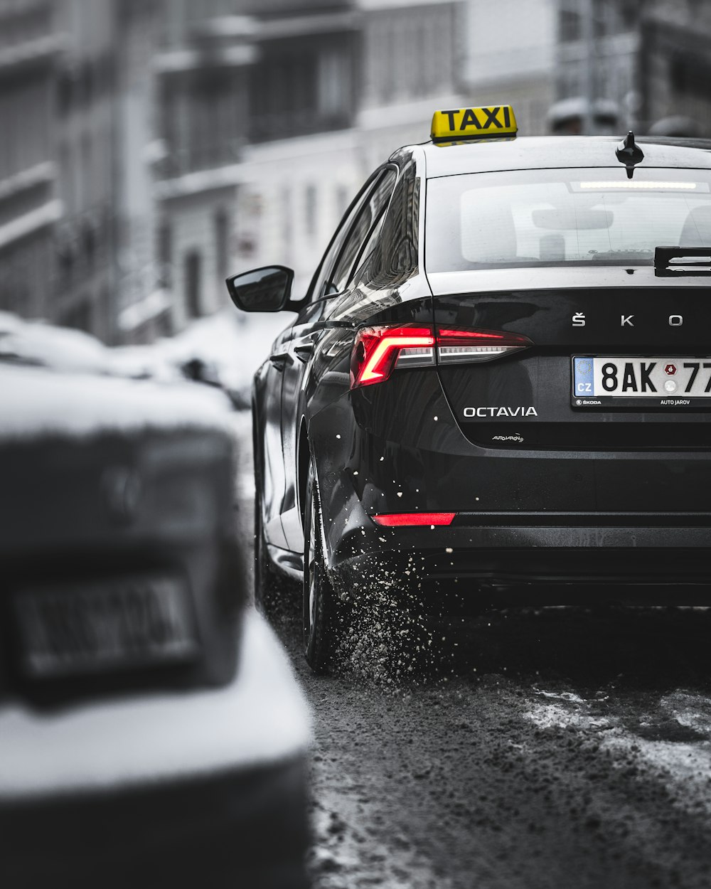 black porsche 911 on snow covered road during daytime