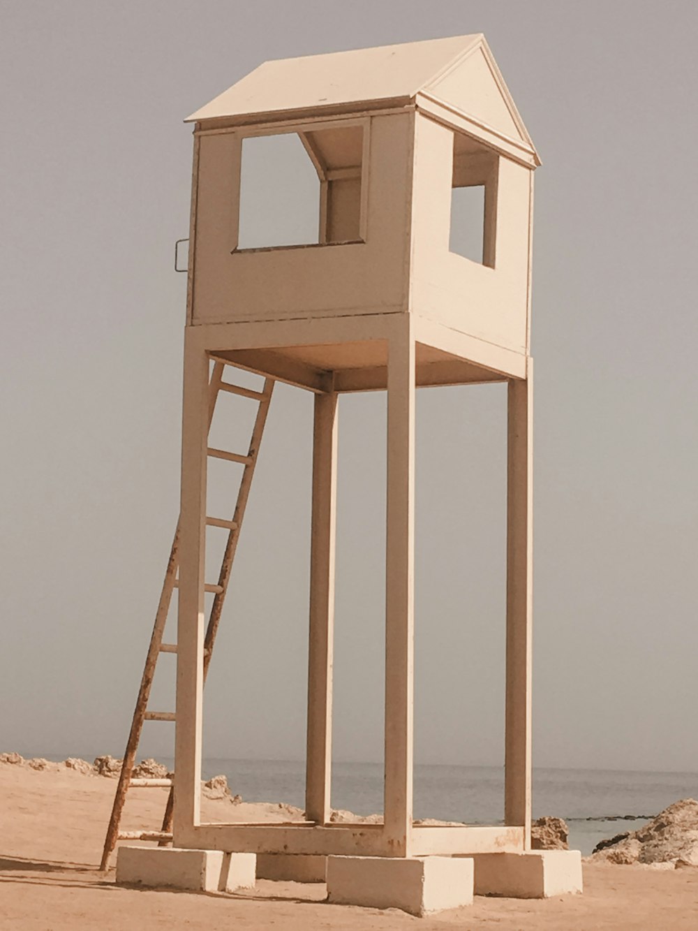 brown wooden lifeguard tower on beach during daytime