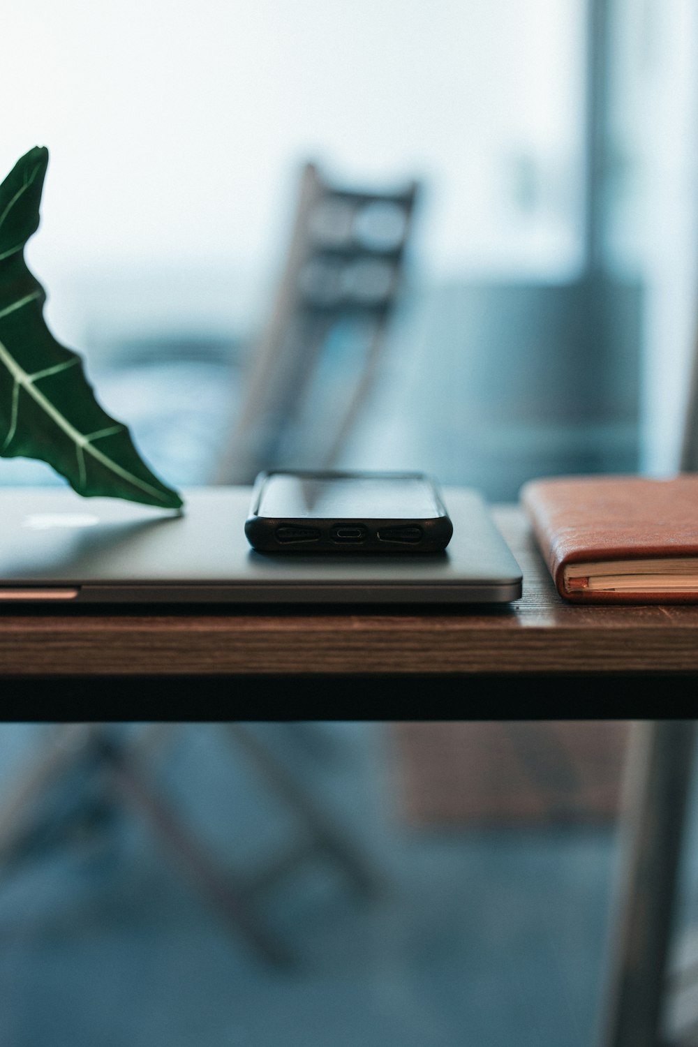 black and silver candybar phone on brown wooden table