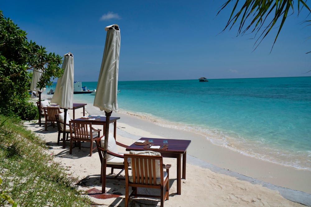 brown wooden chairs on beach during daytime