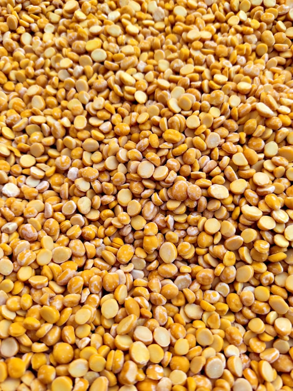 Yellow and brown beans on brown wooden table