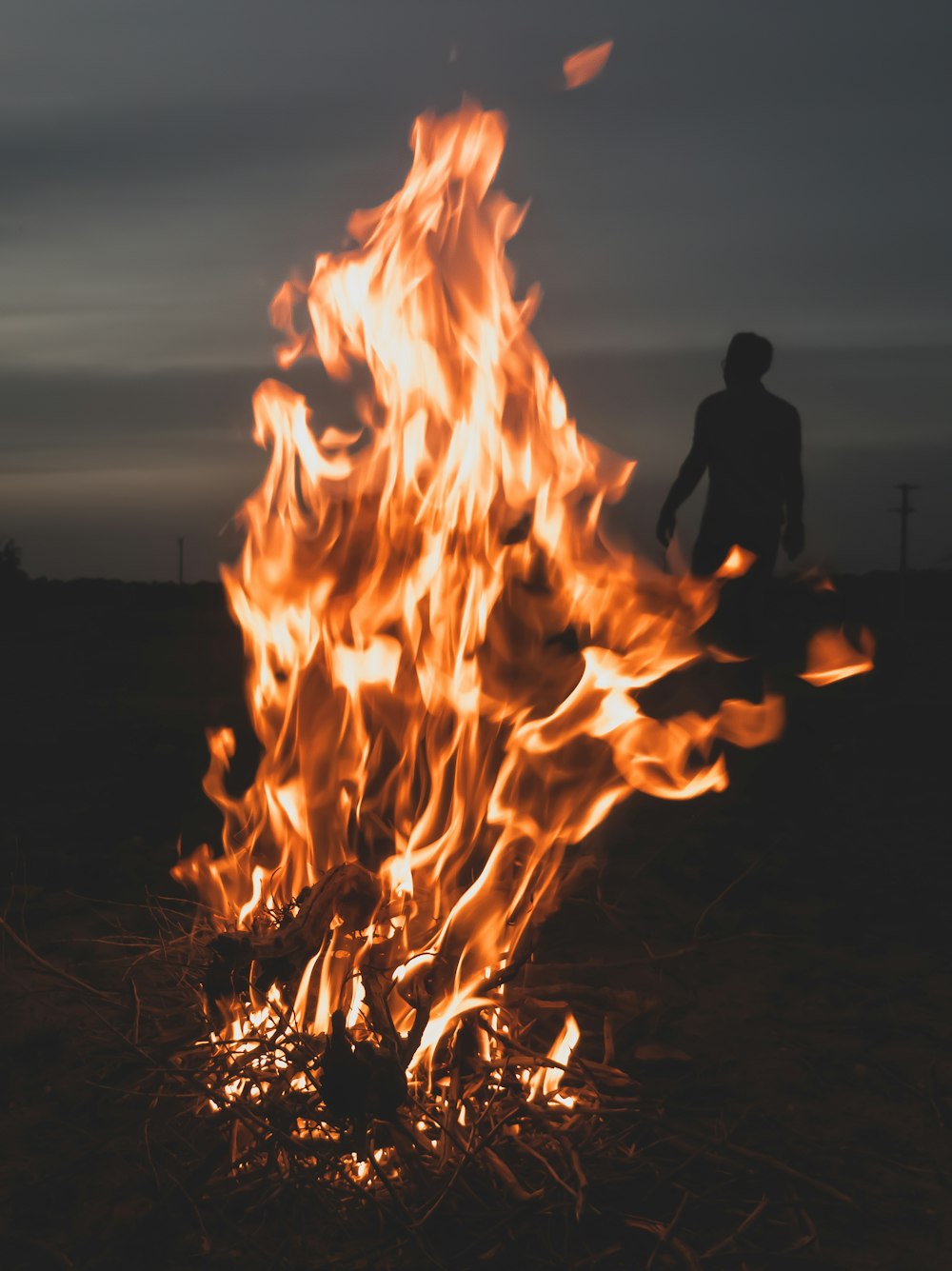 man standing in front of fire