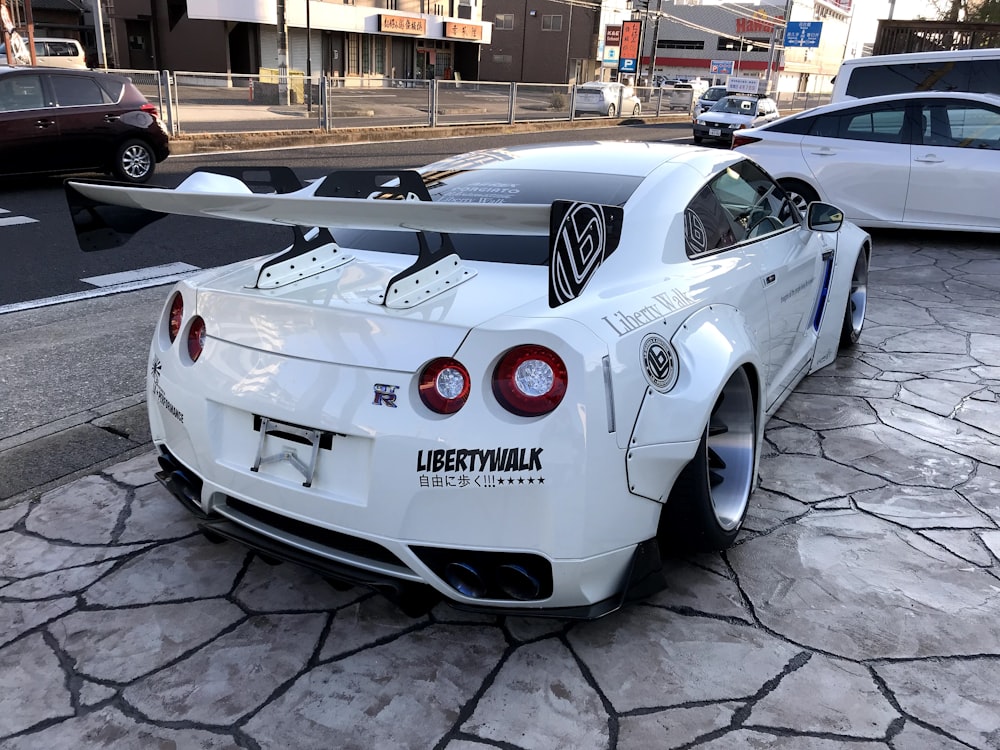 white porsche 911 parked on gray pavement