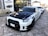 A sleek performance car showcased against an urban backdrop, highlighting its custom modifications.