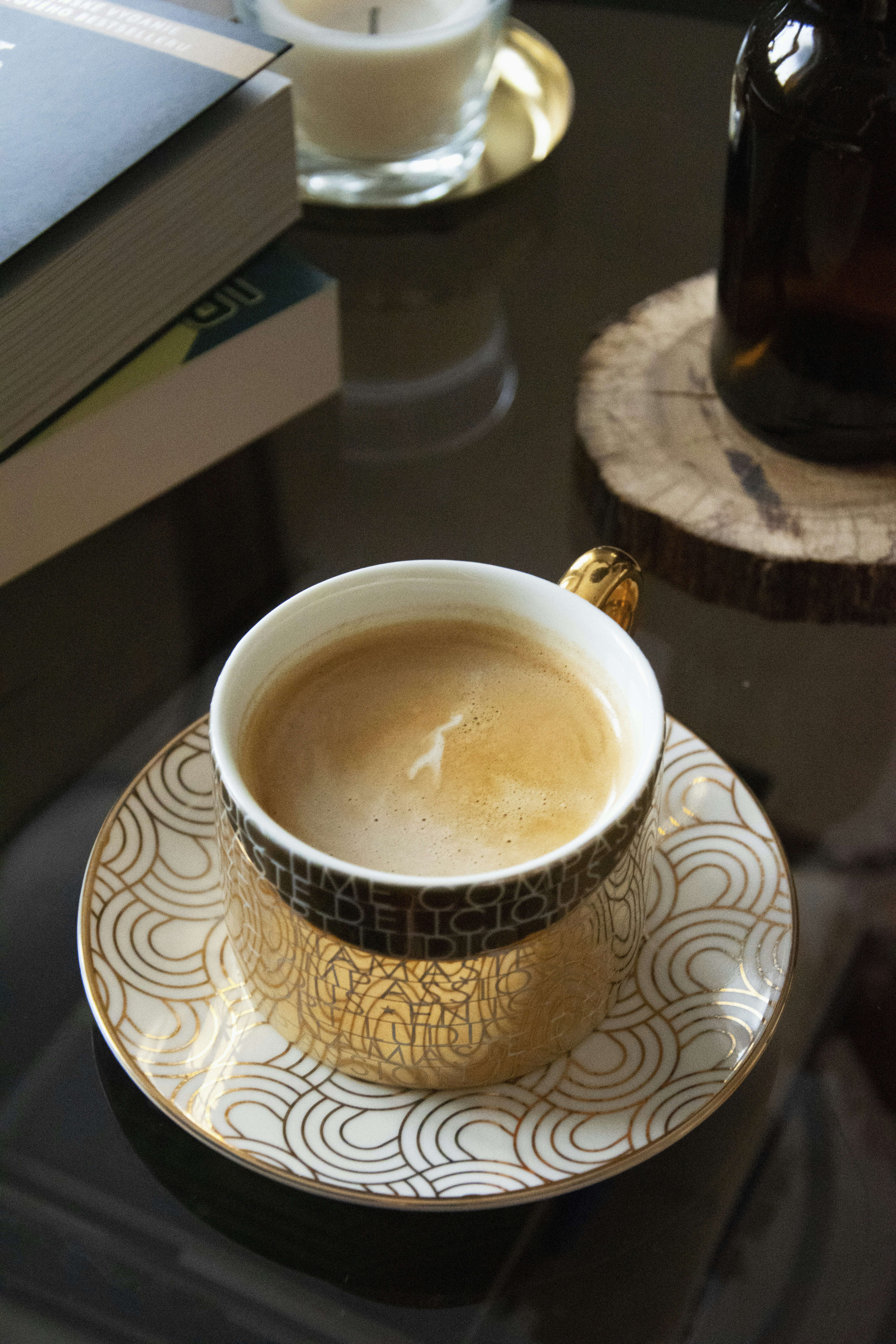 white and black ceramic cup on white and black ceramic saucer