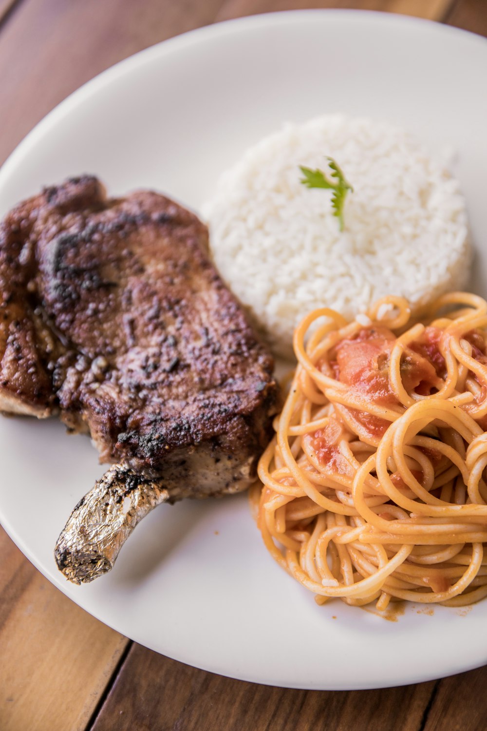 cooked meat with rice on white ceramic plate