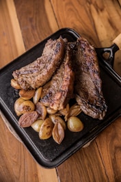 grilled meat on black tray