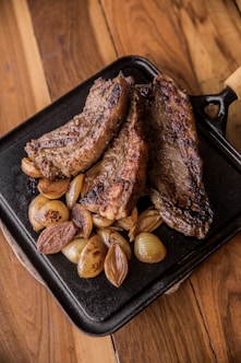 grilled meat on black tray