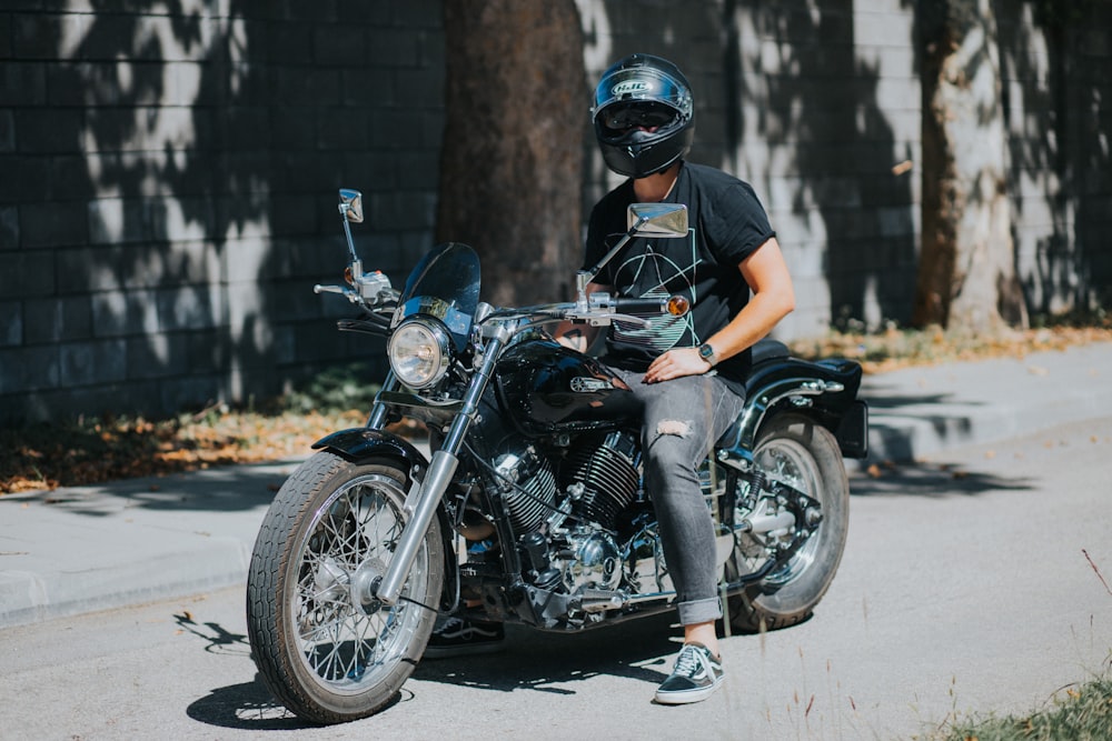 man in orange t-shirt and black helmet riding black motorcycle