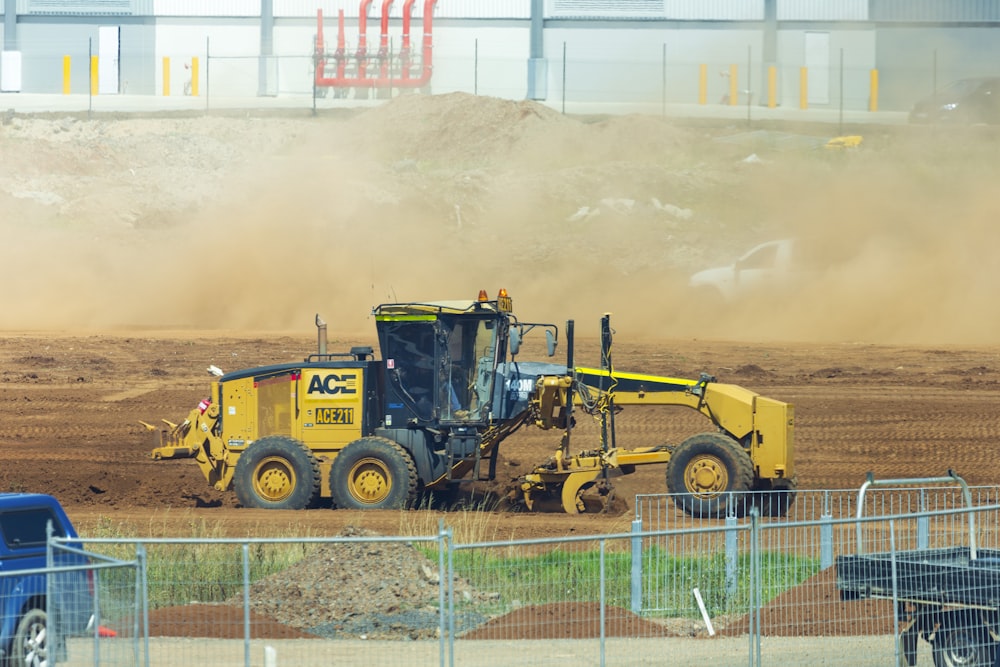 yellow and black heavy equipment on field during daytime