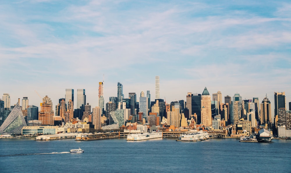 city skyline across body of water during daytime