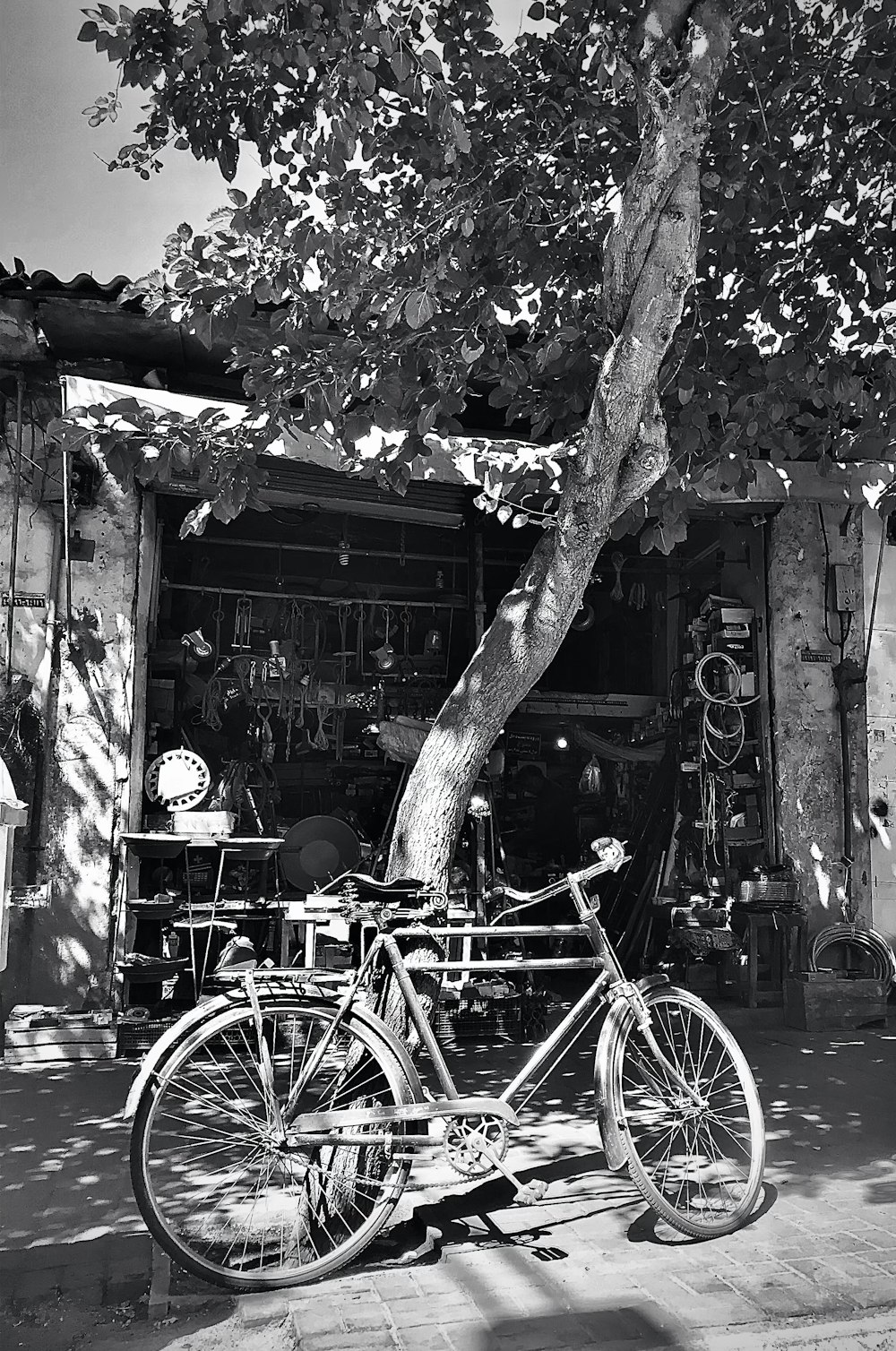 black city bike parked beside brown wooden house