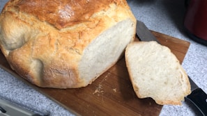 A warm loaf of bread fresh from the oven, with a golden crust and soft interior.
