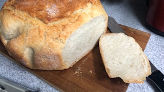 A golden, fluffy slice of buttermilk cornbread resting on a rustic wooden board.