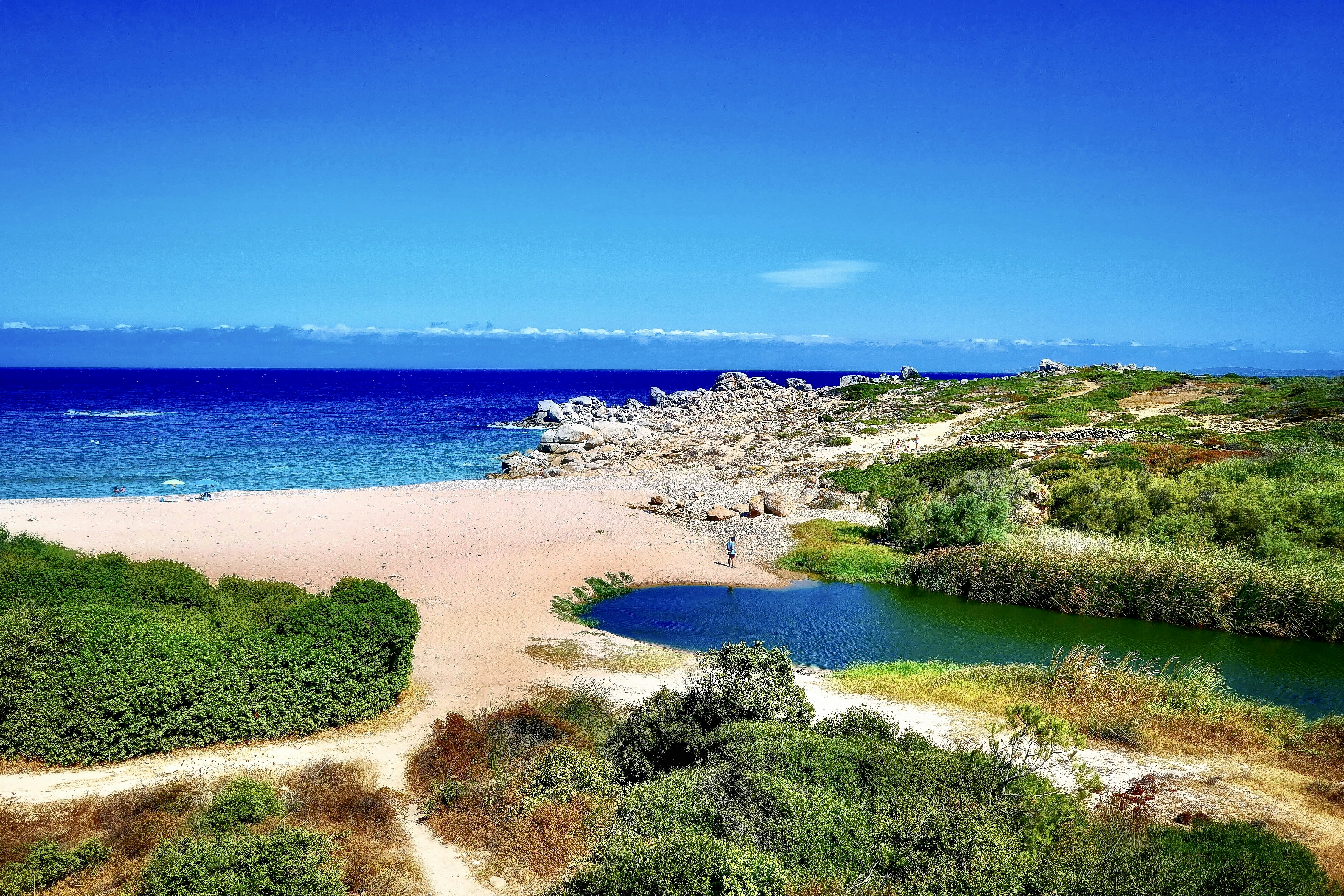 green grass field near body of water during daytime, Gallura, Sardinia 