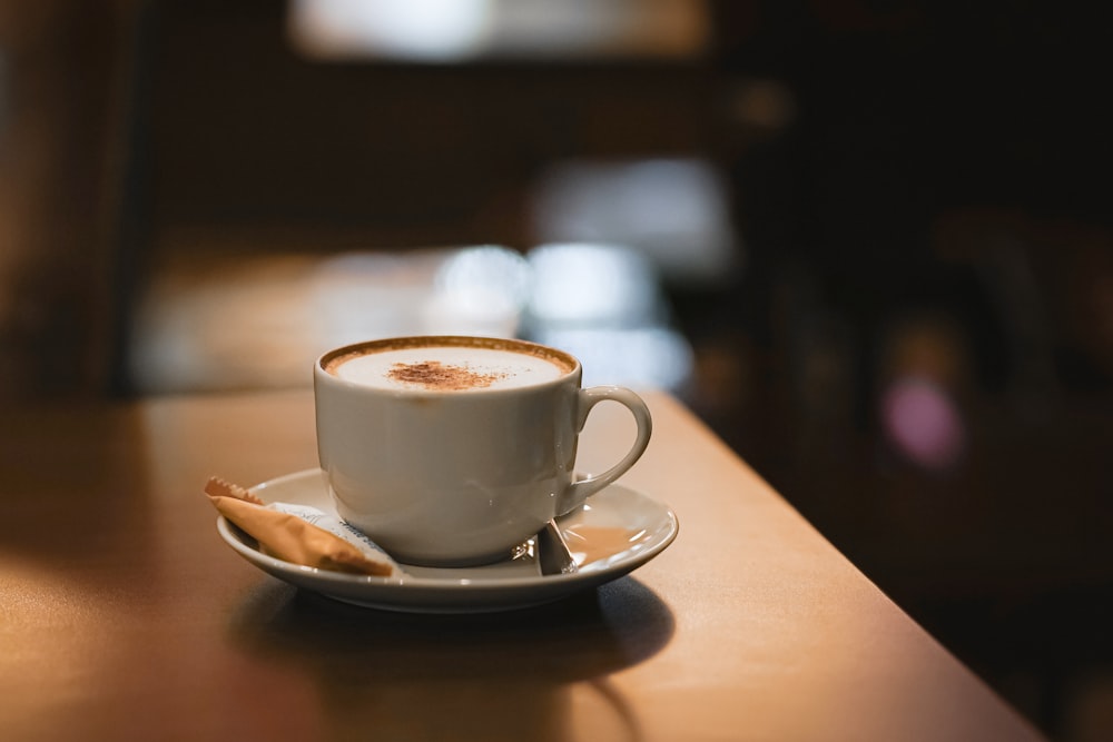 white ceramic cup on saucer