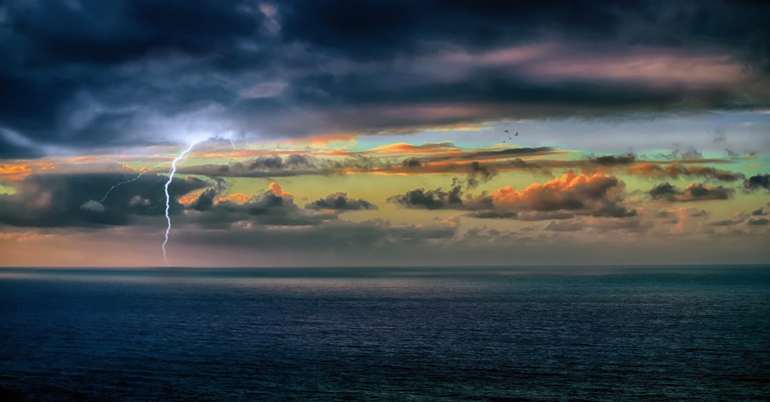 body of water under cloudy sky during daytime