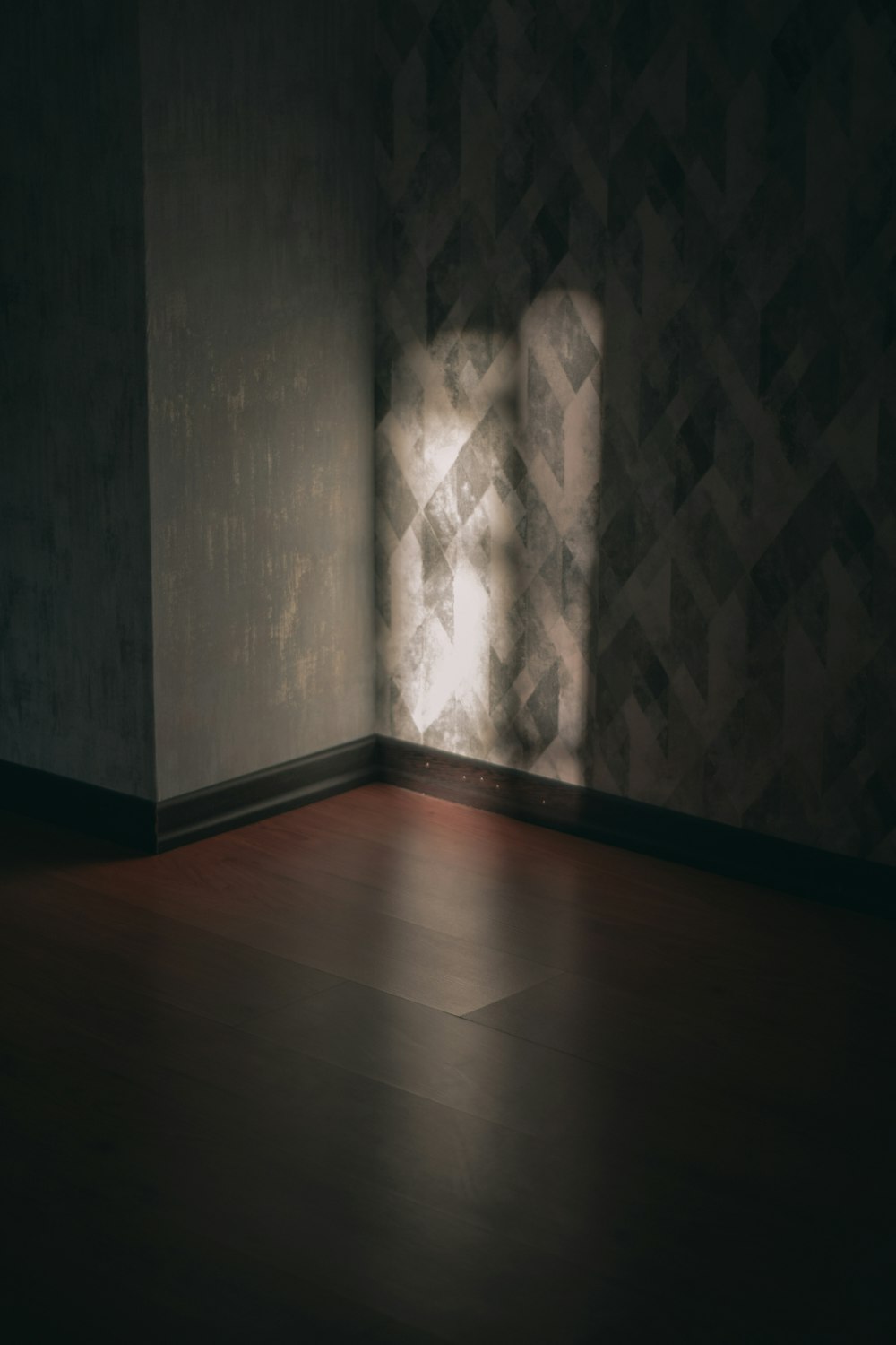 brown wooden parquet floor and white wall