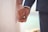 man in black suit jacket holding hands with woman in white dress
