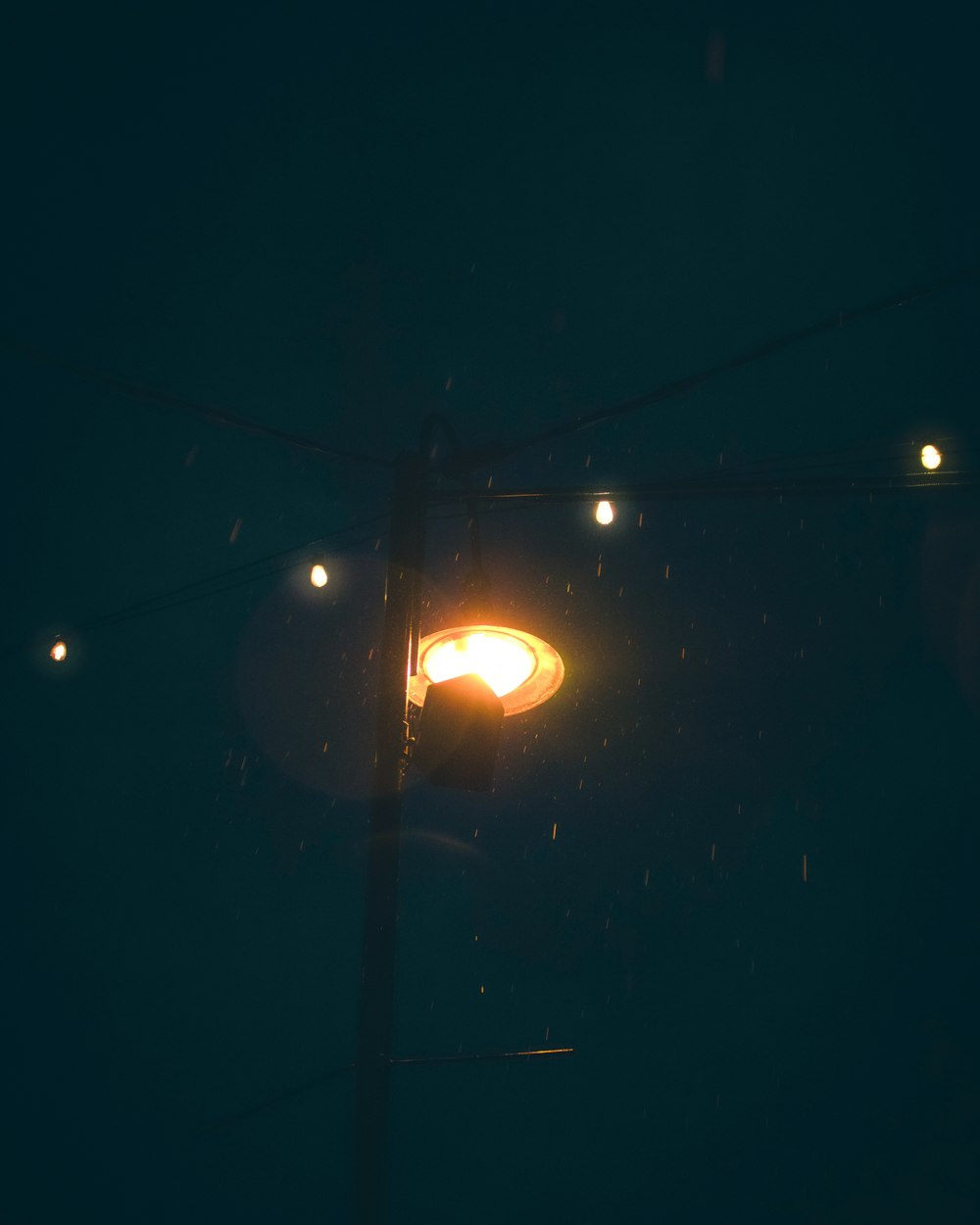black street light turned on during night time