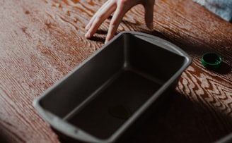 black iphone on brown wooden table