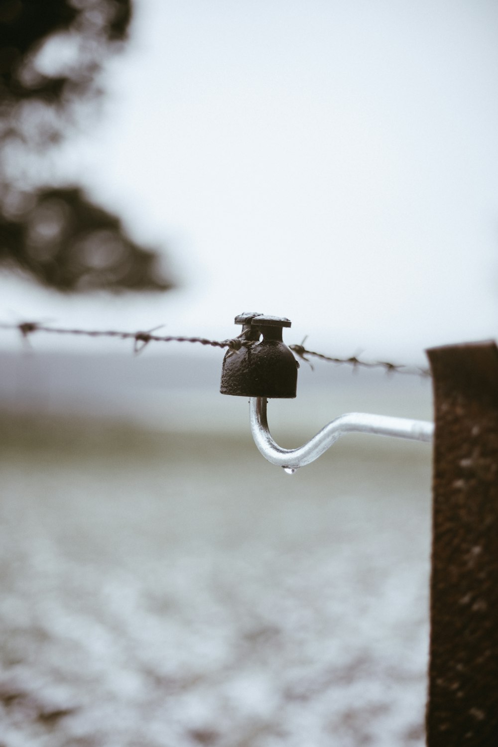 black padlock on white metal bar