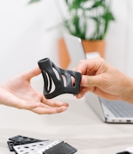 person holding black and white nike shoe