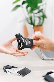 person holding black orthopedics knee support