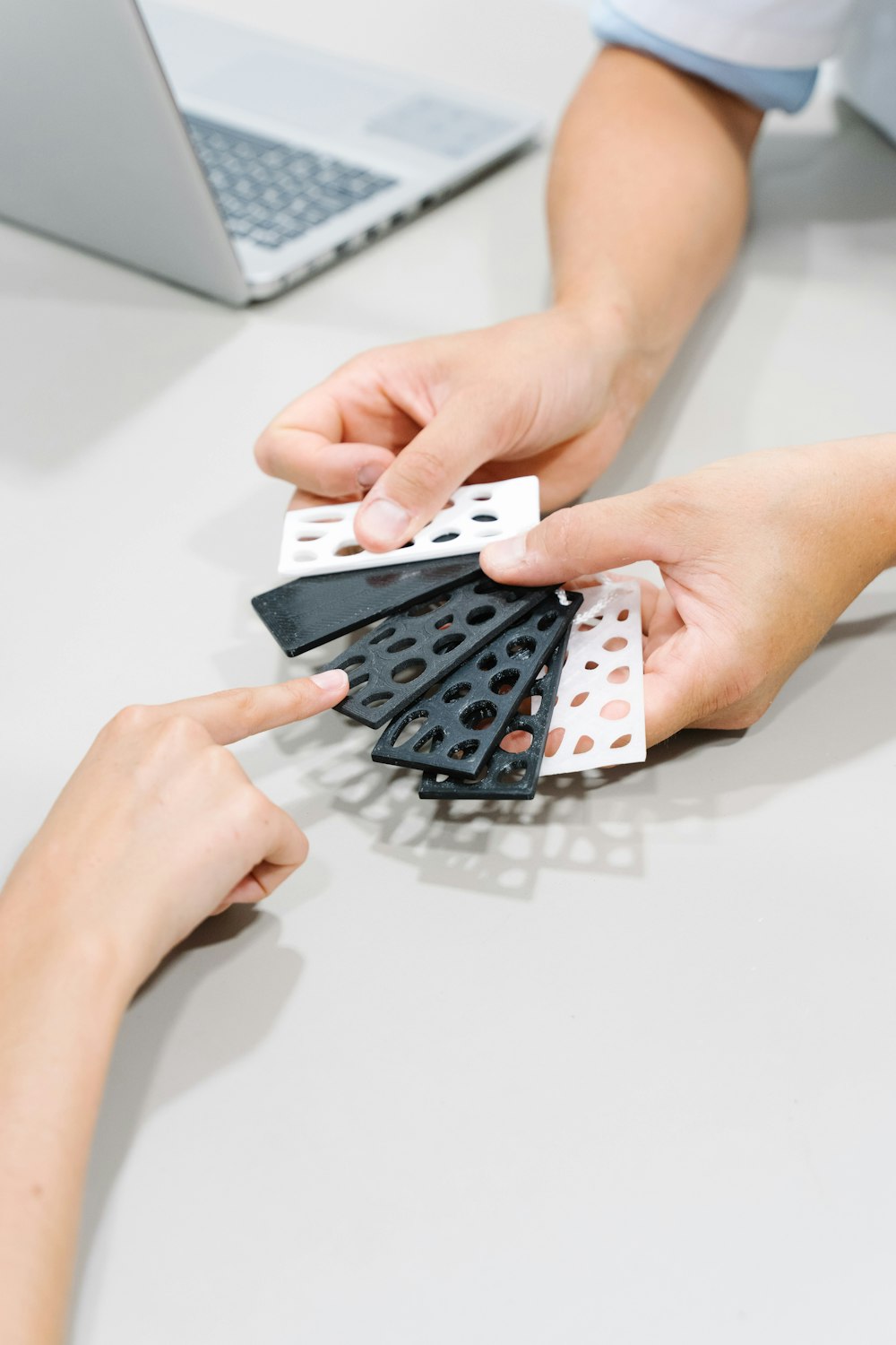 person holding black and white polka dot print textile