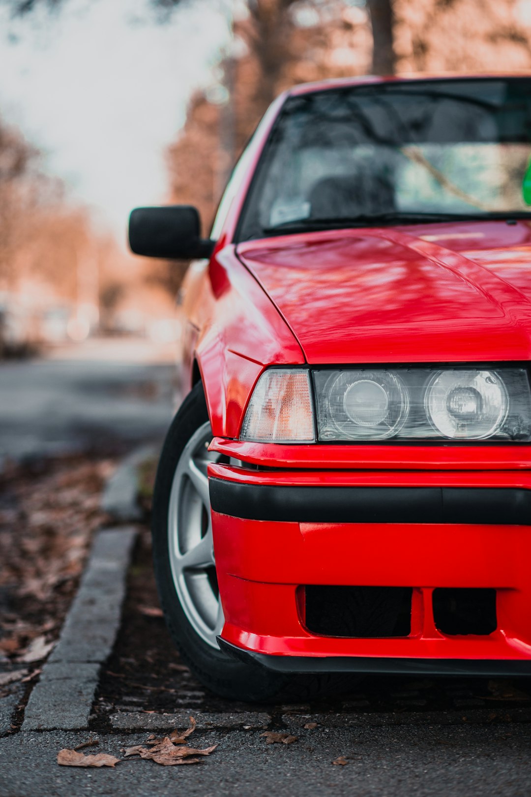 red bmw car on road during daytime