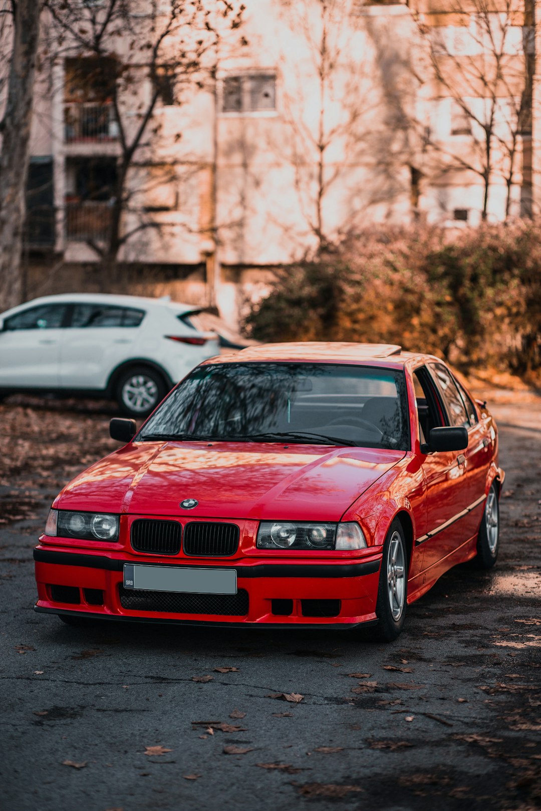 red bmw m 3 parked on street during daytime