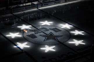 A sleek ice hockey rink under bright lights with a player poised to shoot, embodying speed and precision.