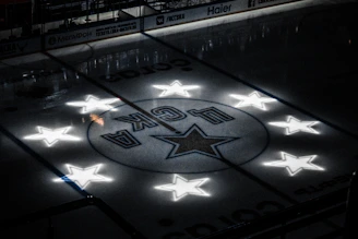 A sleek ice hockey rink under bright lights with a player poised for a powerful shot.