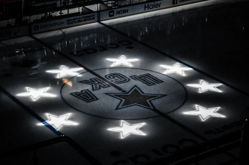 A shimmering ice rink illuminated under soft blue lights.
