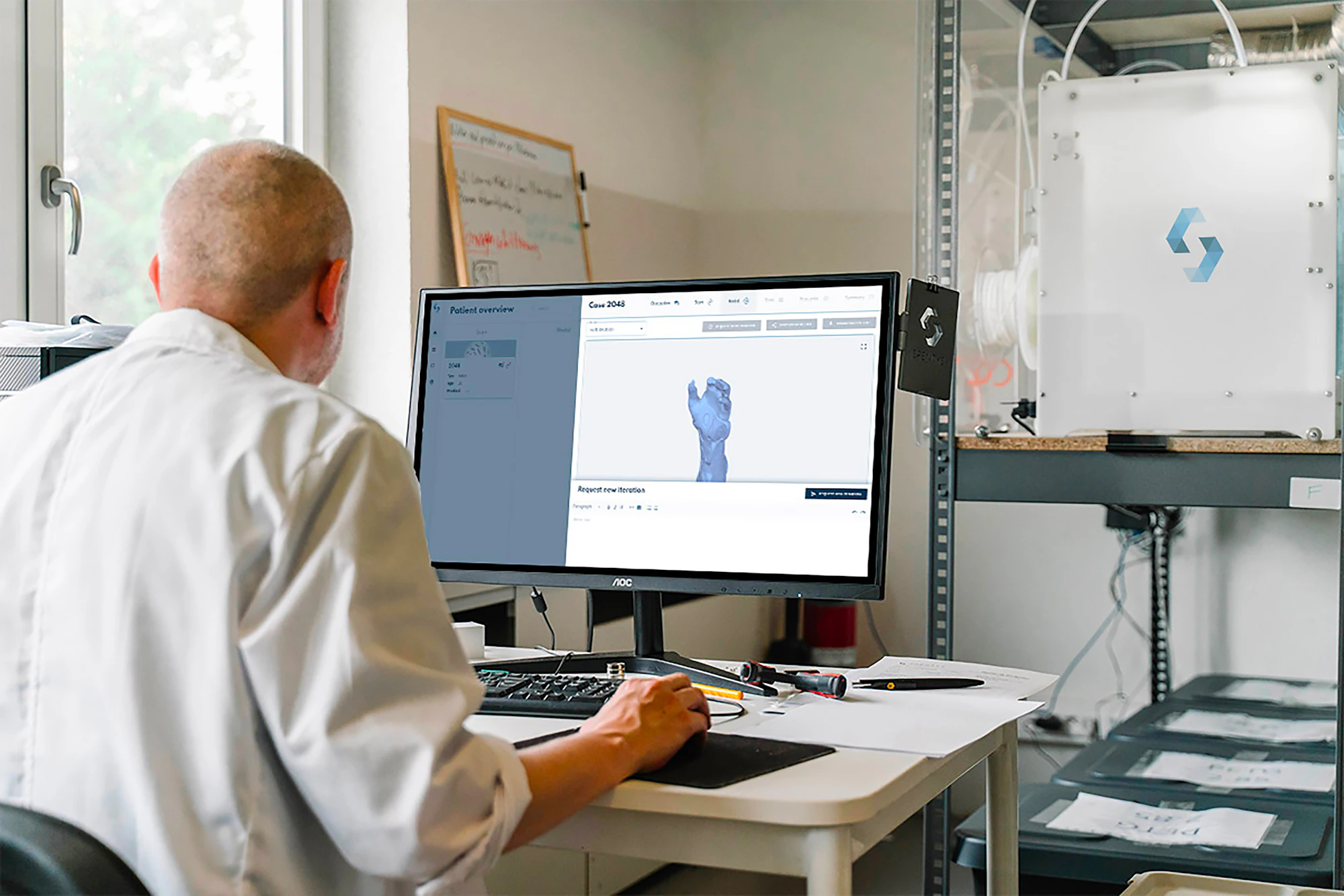 Modeler working with a 3D scan at a computer workstation