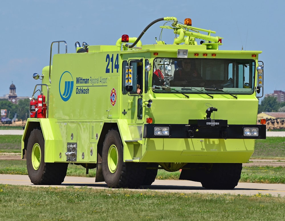 green and red fire truck on road during daytime