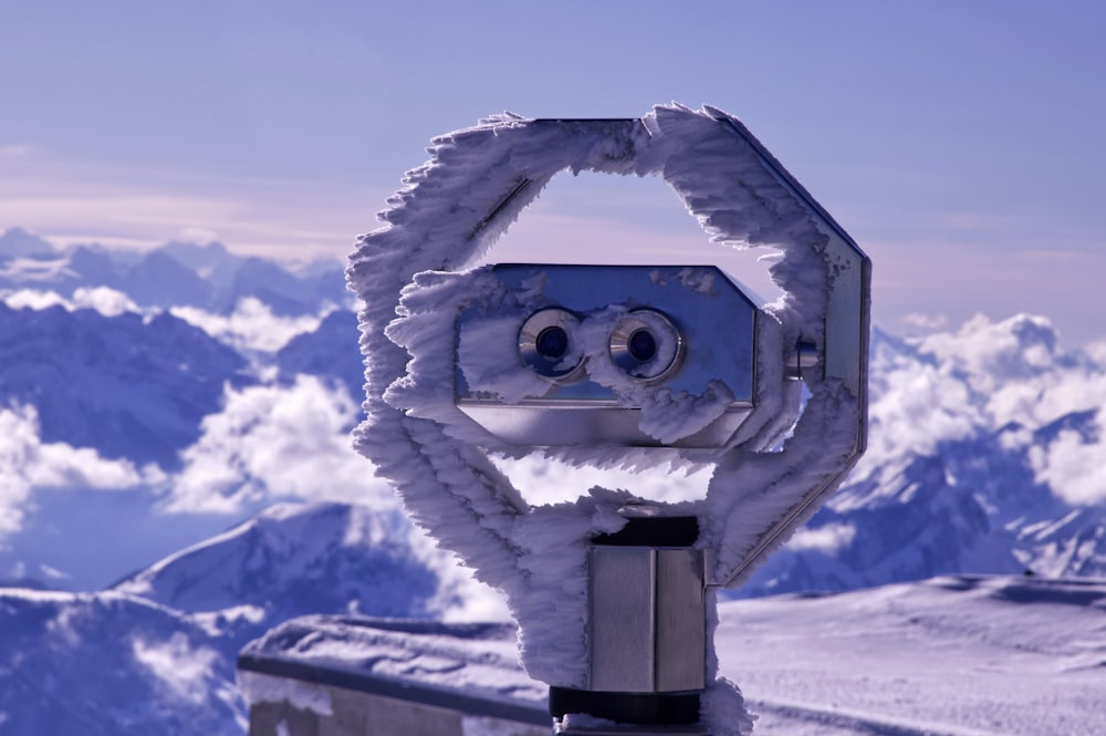 gray and black telescope on snow covered ground during daytime