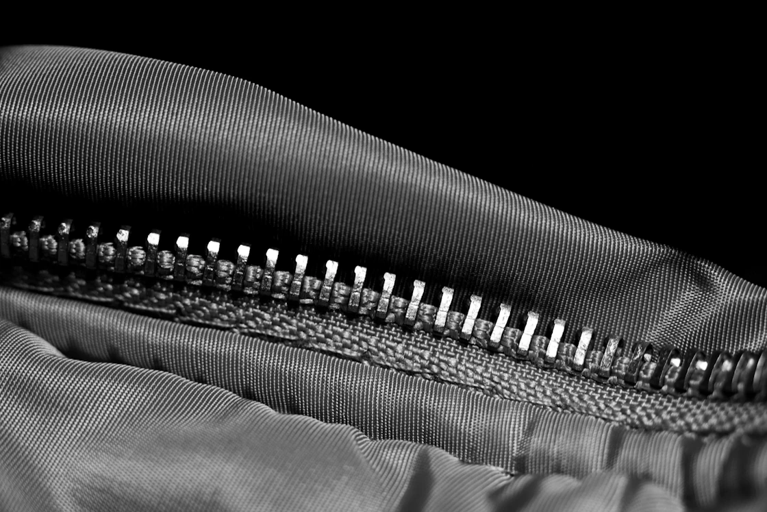 A close view of black and white striped fabric showing the weave and the stitching along a seam.