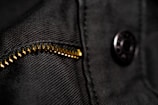 Close-up of detailed stitching and fabric texture on a Lumina Apparel hoodie under soft natural light.
