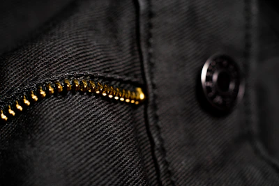 Artistic shot of Luxureviva clothing details highlighting fabric texture and stitching.