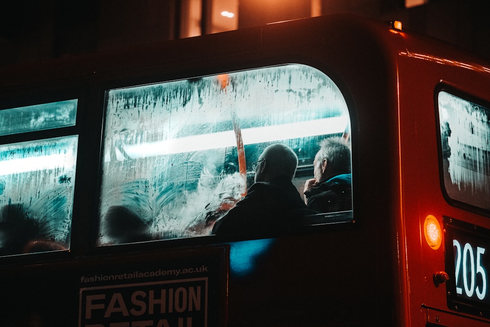 man in black jacket sitting on car seat