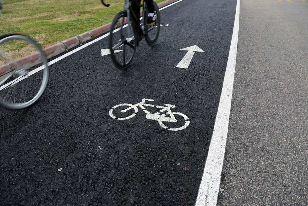 Bicicletta nera su strada asfaltata nera