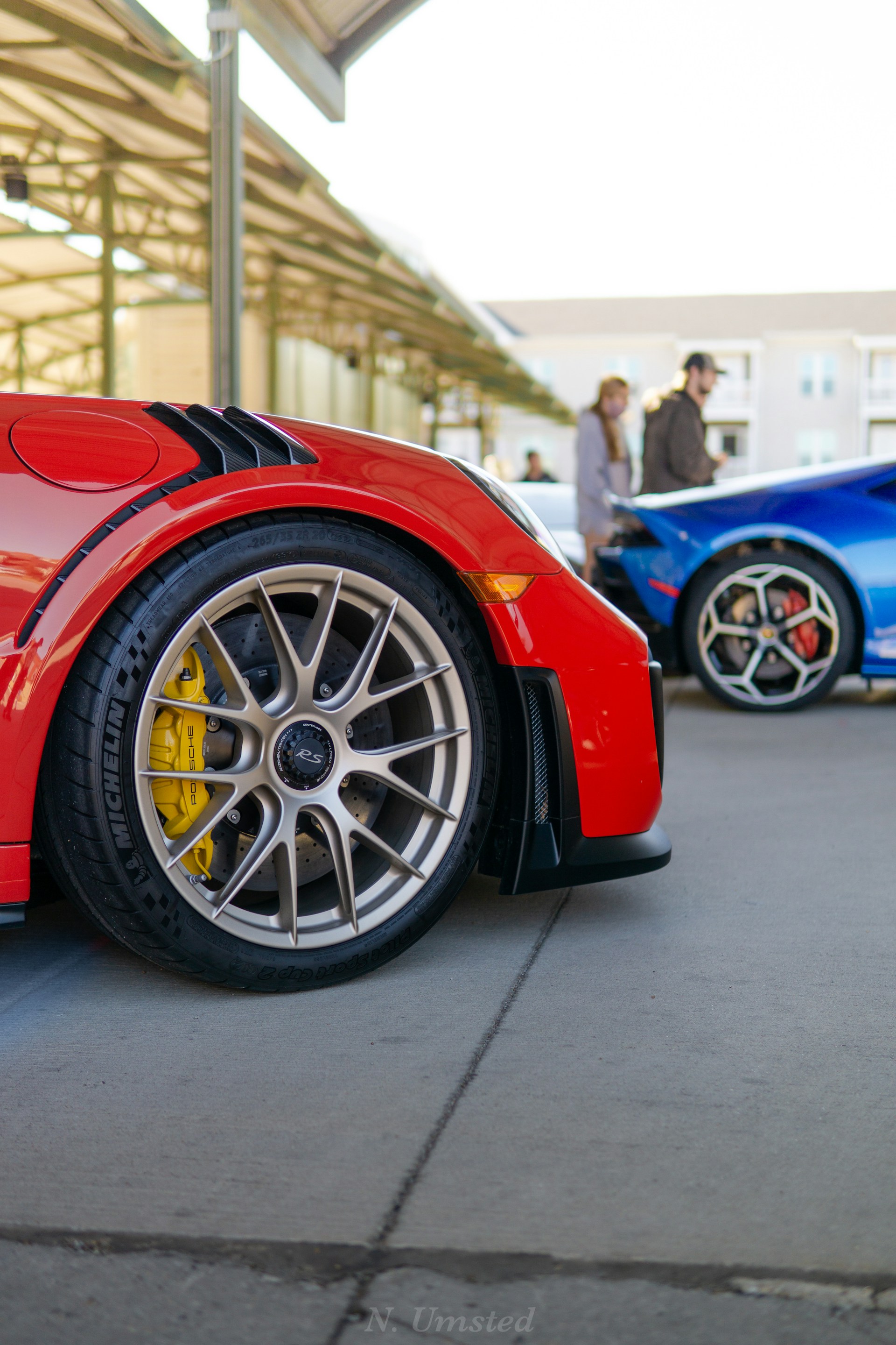 red ferrari car in a parking lot