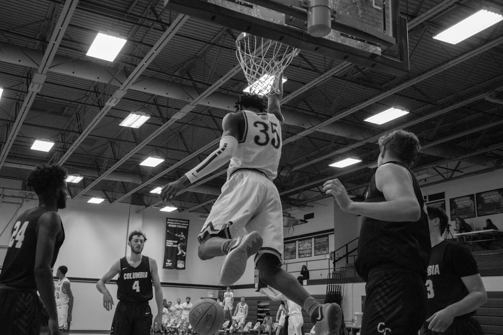 grayscale photo of basketball players playing basketball